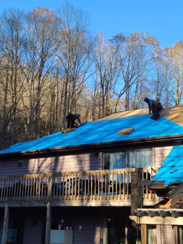 Roof Installation in Liberty, KY. Three roofers laying new shingle on a roof in Liberty.